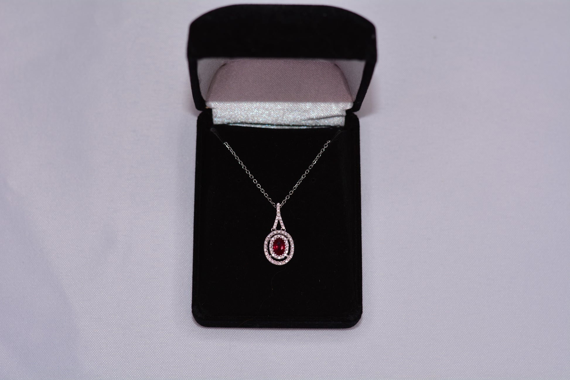 18KT White Gold Ruby Pendant with Diamond Halo