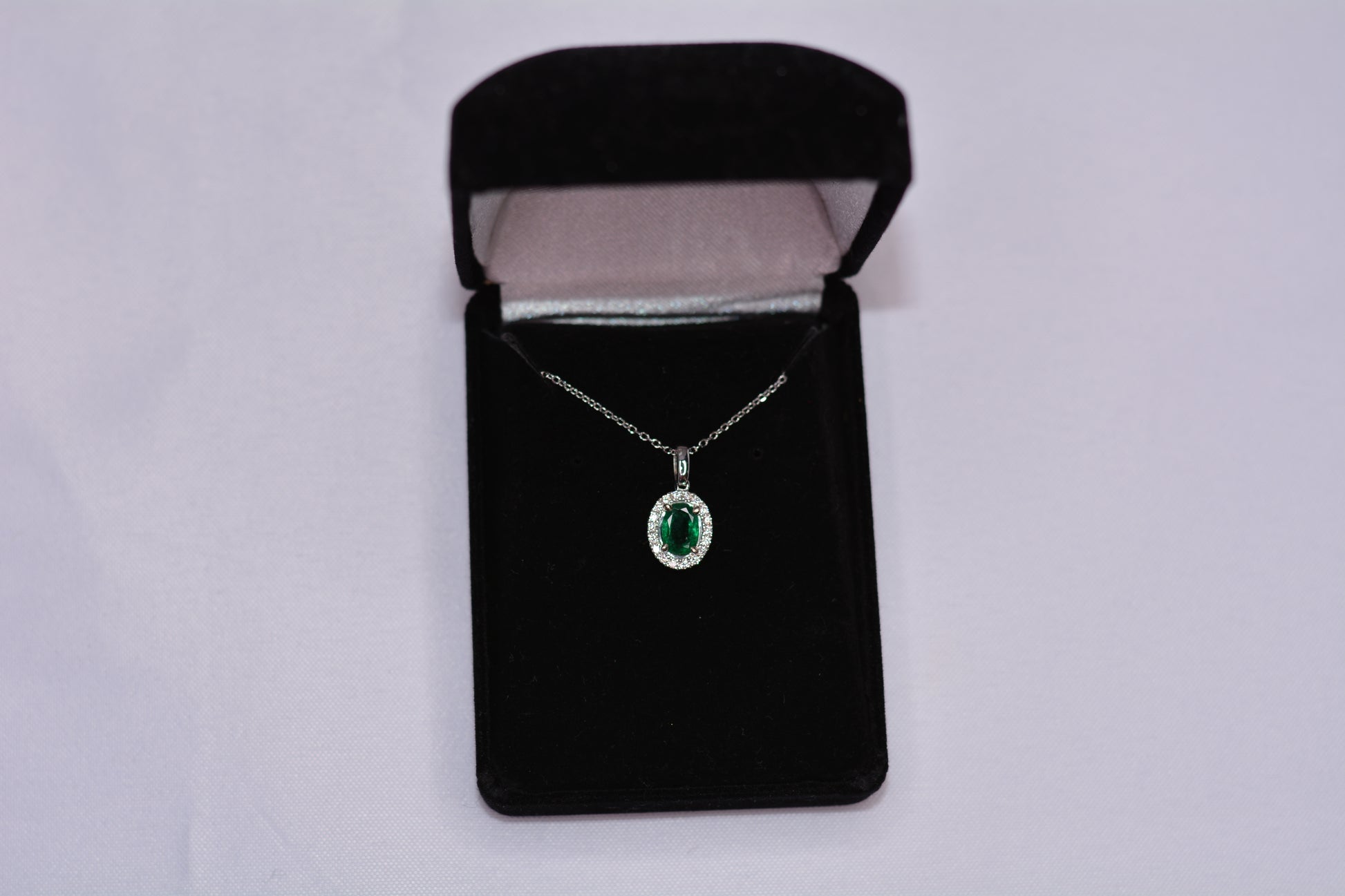 14KT White Gold Oval Emerald Pendant with Diamond Halo